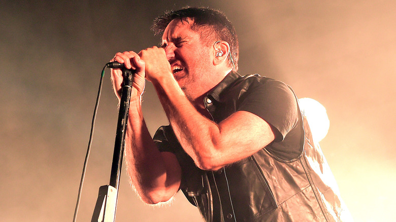 Trent Reznor singing orange-lit