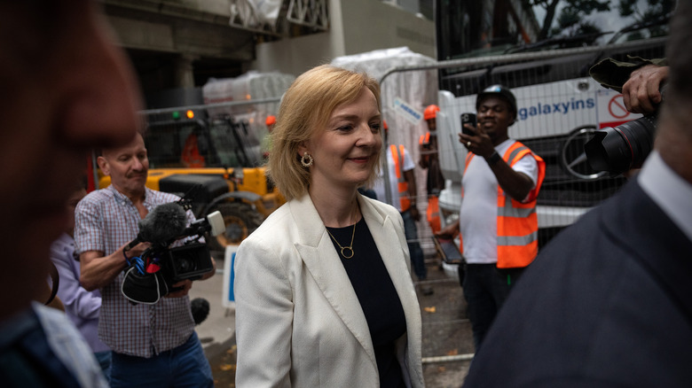 Liz Tuss being filmed on the street