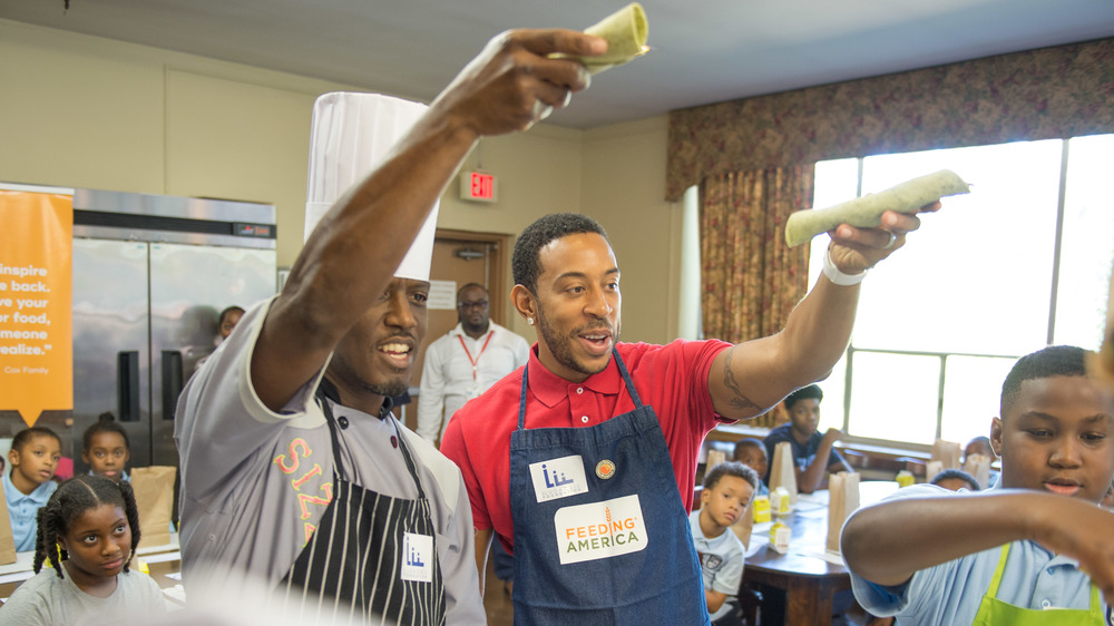 Ludacris holding up a tortilla wrap 