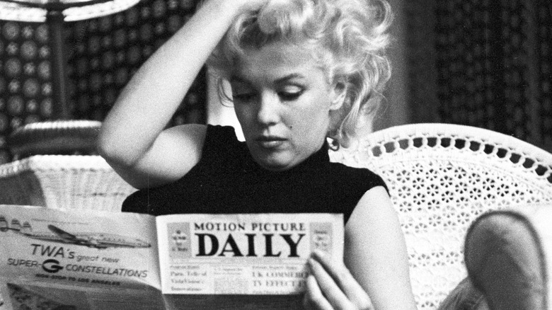 Monroe reading a newspaper