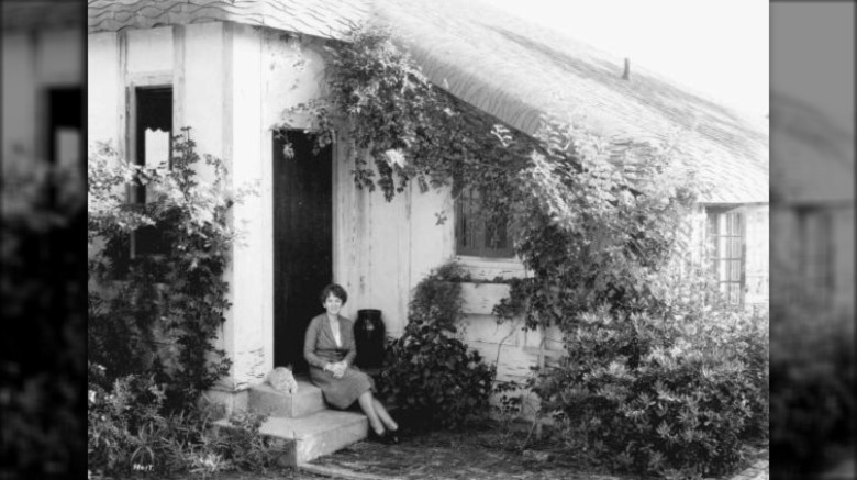 Marjory Stoneman Douglas sitting in front of her home, c. 1920