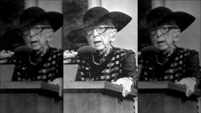 Marjory Stoneman Douglas speaking at podium while wearing black hat