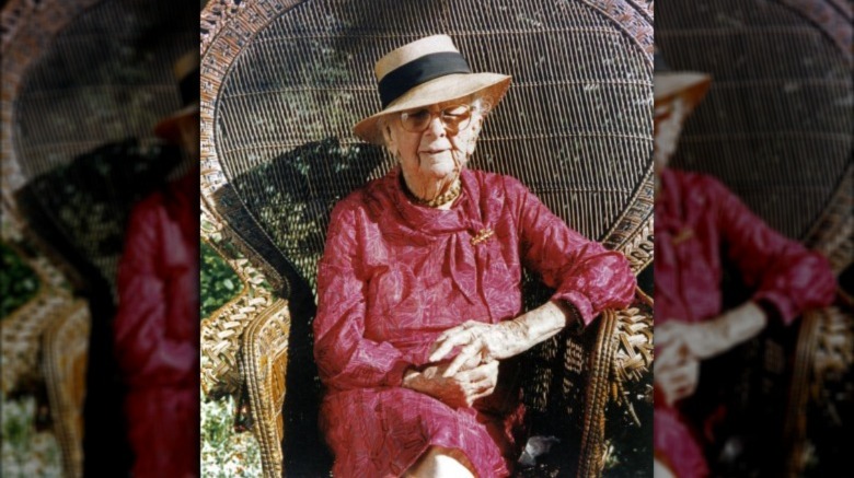 Color photo portrait of Marjory Stoneman Douglas sitting in wicker chair