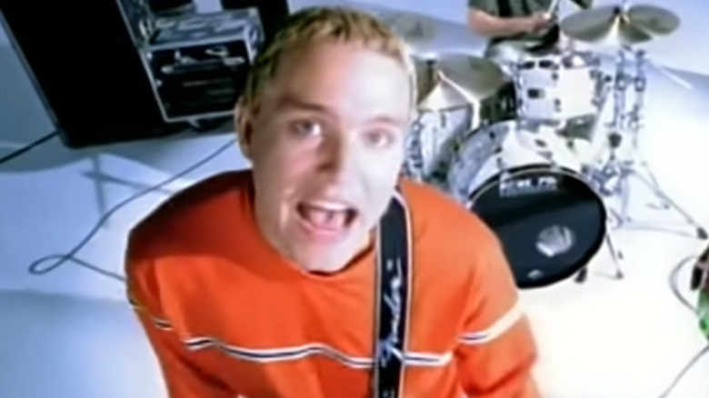 Mark Hoppus singing in orange sweater "Dammit" video