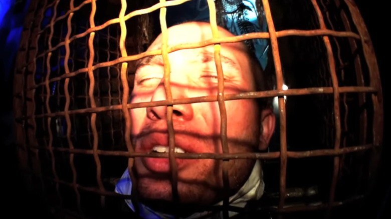 Man trapped in cage