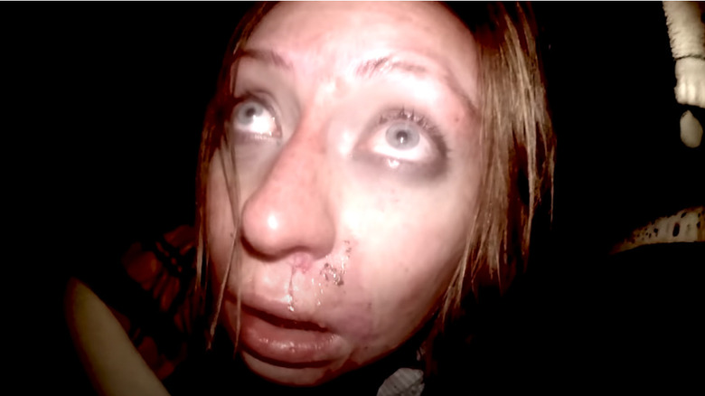 Frightened woman talking into camera