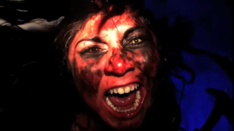 Woman screaming with face painted red