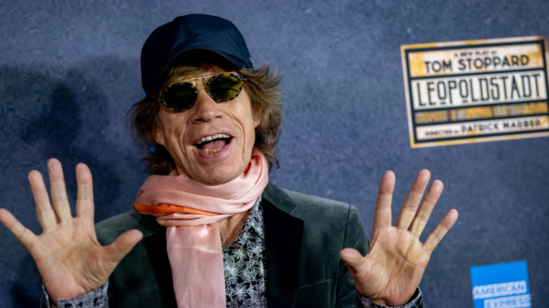 Mick Jagger hat sunglasses waving hands