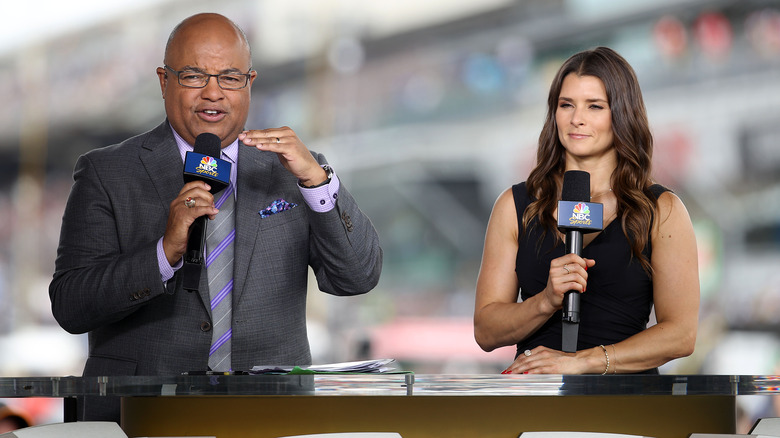 Mike Tirico holding baseball