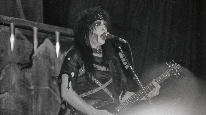 Mick Mars performing with Crue