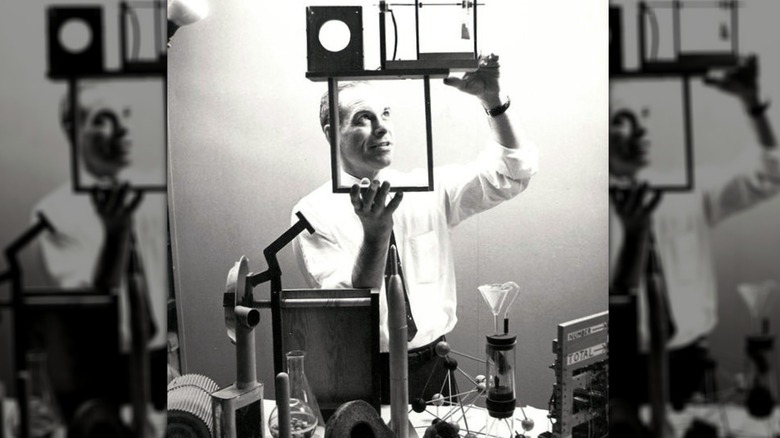 Mr. Wizard holding experiment apparatus