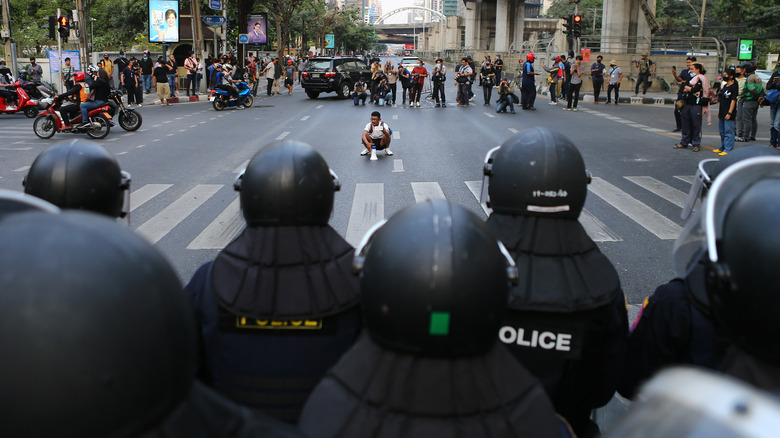 Military police and pro-democracy protestors face off in the street