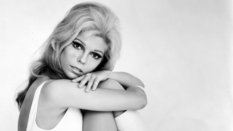 Nancy Sinatra, hugging her knees