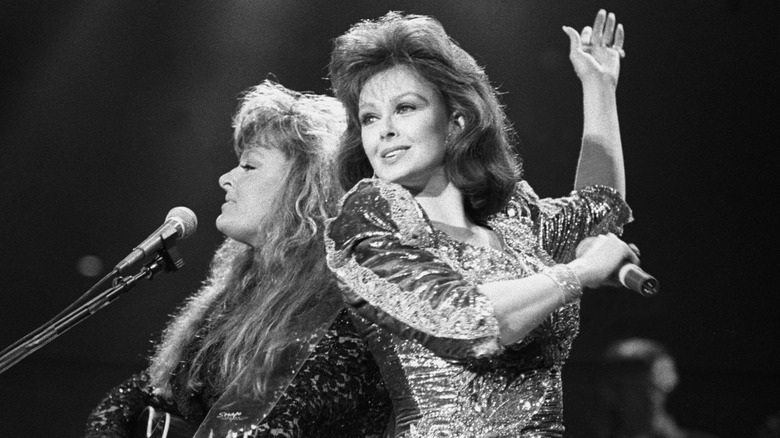 Wynonna and Naomi Judd of the country music duo The Judds are shown performing on stage during a "live" concert appearance on April 12, 1991