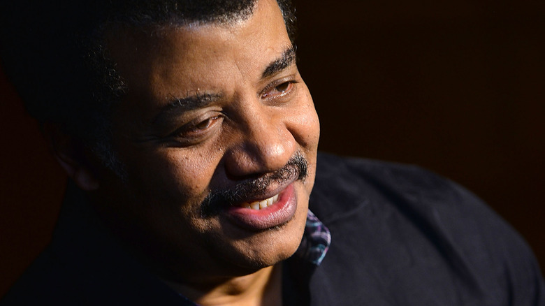 Neil deGrasse Tyson looking down