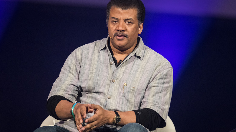 Neil deGrasse Tyson in a grey shirt