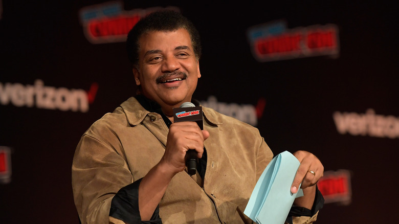 Neil deGrasse Tyson holding mic