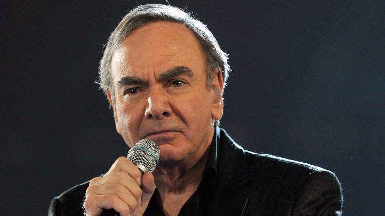 Neil Diamond on stage holding mic black shirt