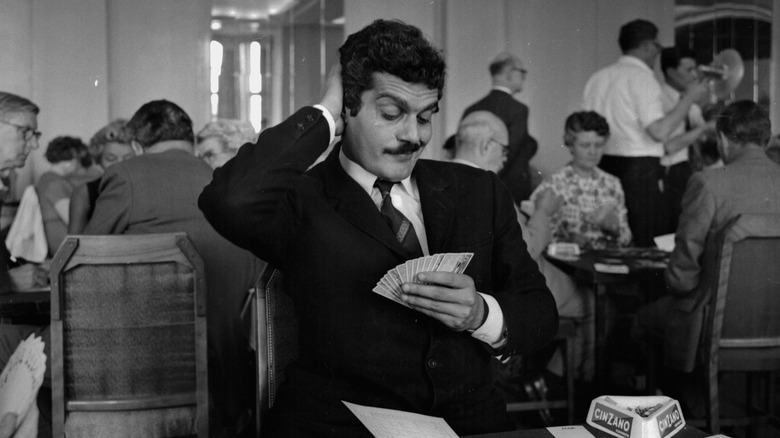 Omar Sharif playing cards in a candid photo 