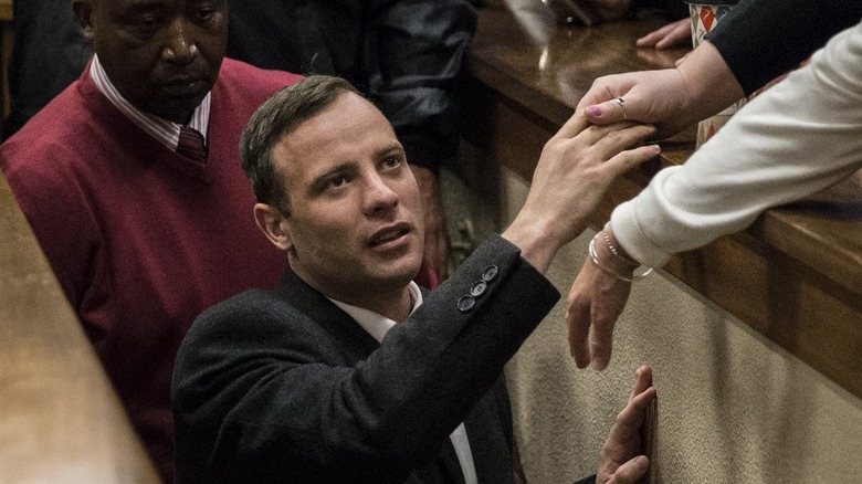 Oscar Pistorius grabbing sister's hand