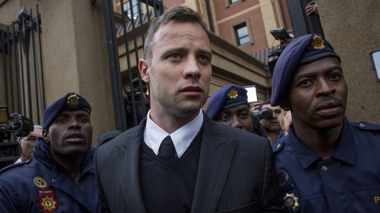 Oscar Pistorius wearing suit exiting court