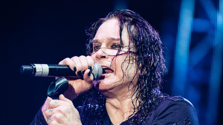 Ozzy Osbourne singing in a microphone