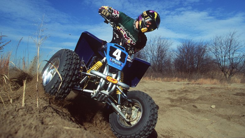 Stock photo of a man riding a quad bike