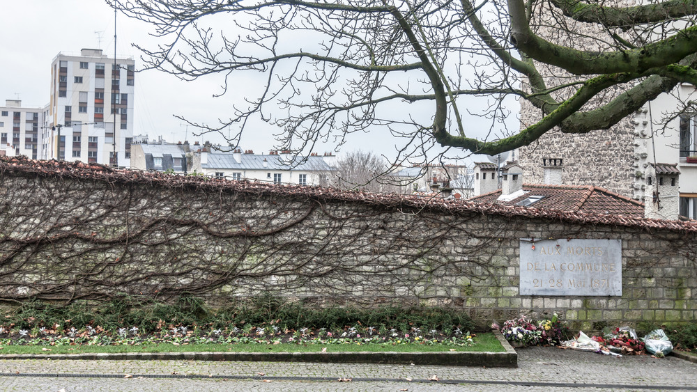 The Communards Wall, with tall building in the background