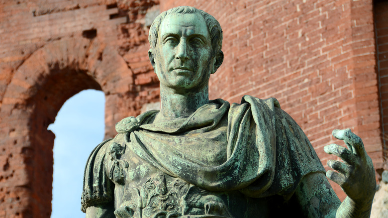 statue of Julius Caesar in front of the Porta Palatina