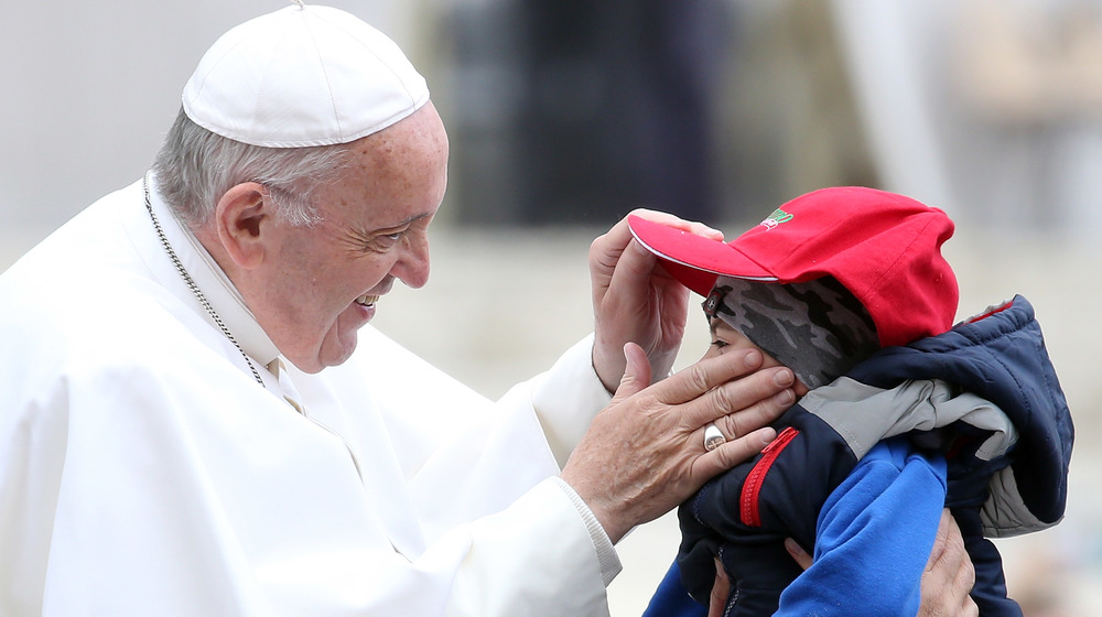 Pope Francis greets child