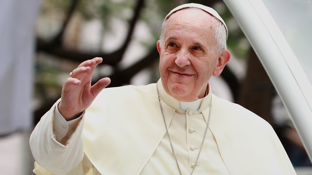 Pope Francis raises hand in greeting