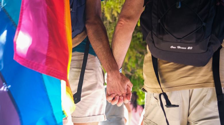 two men holding hands