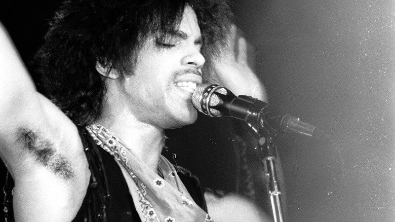 Prince performing with straightened hair and vest in 1981