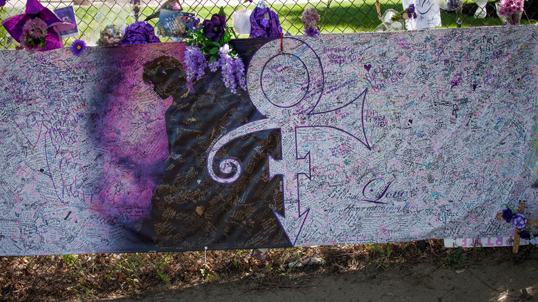 A memorial banner outside Prince's Paisley Park home showing the love symbol