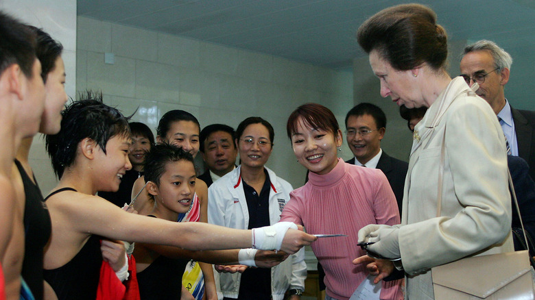 Princess Anne greets children at a Save the Children function