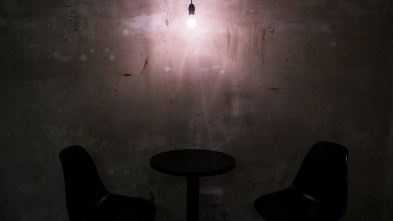 A dimly lit room with hanging bulb