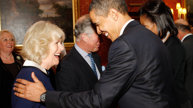 Camilla and Barack Obama laughing