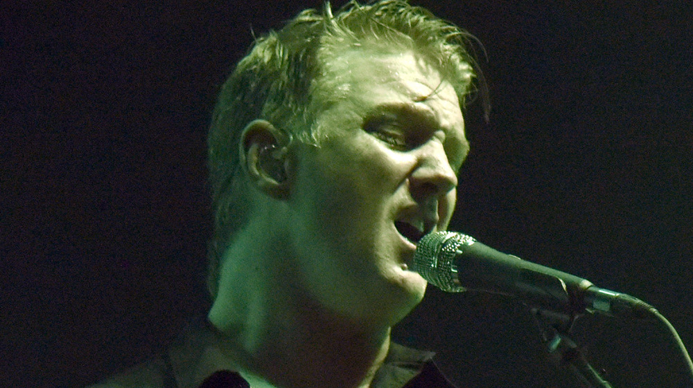 Josh Homme singing at mic