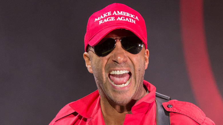 Tom Morello performing in a red outfit