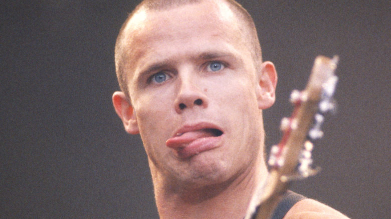 Flea of the Red Hot Chili Peppers making a funny face while performing