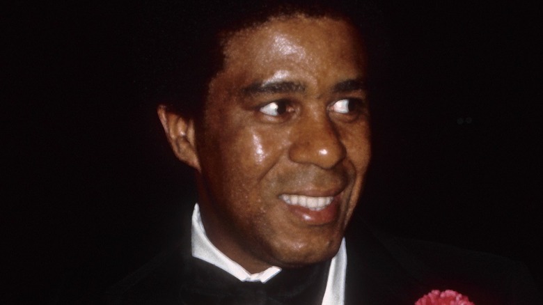 Richard Pryor smiling in a tuxedo at Grammy Awards