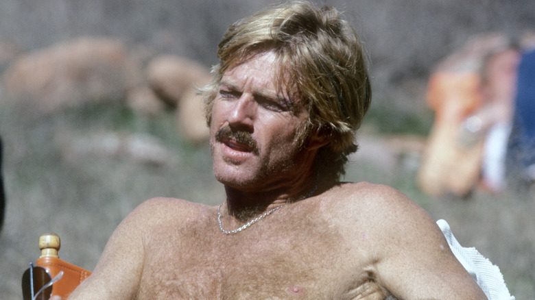 Robert Redford shirtless and seated