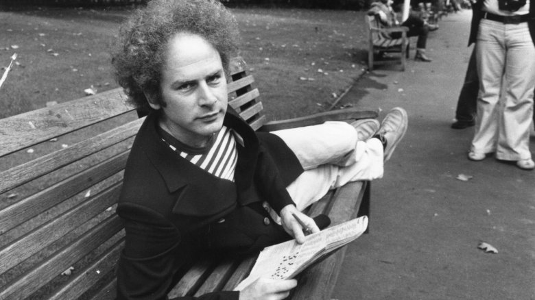 Art Garfunkel laying on bench