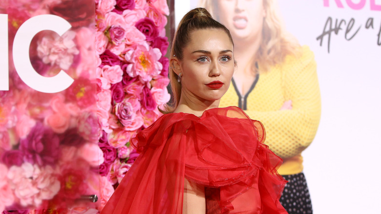 Miley Cyrus in red dress and lipstick