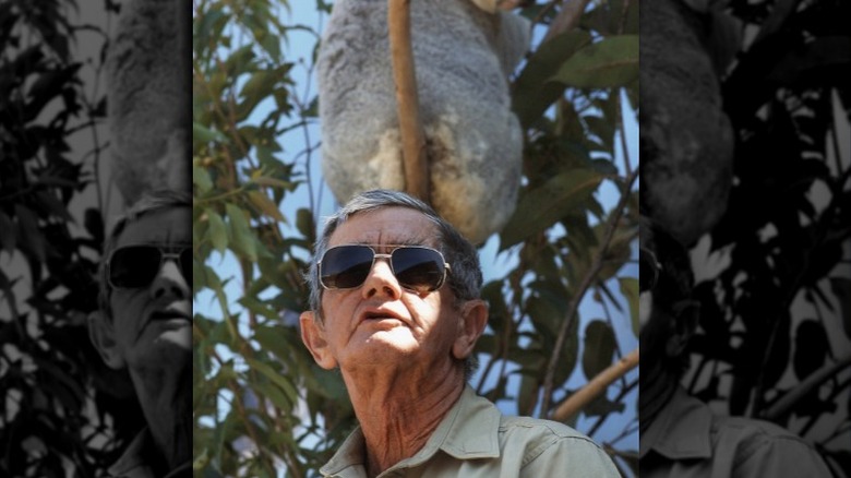 Bob Irwin sitting beneath koala 