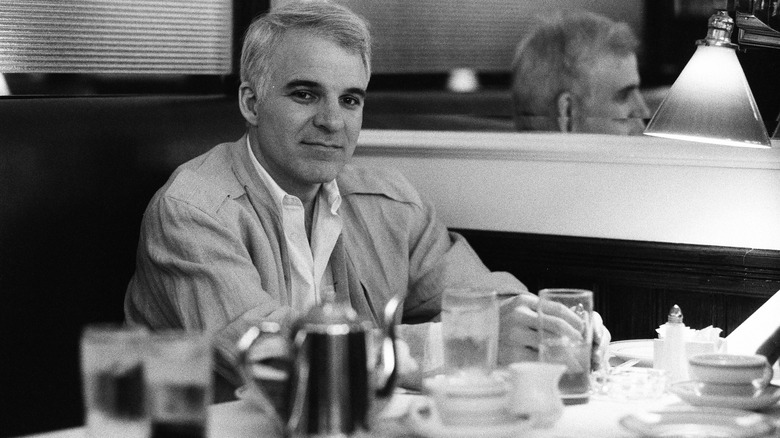 Steve Martin sitting in a diner 1980s