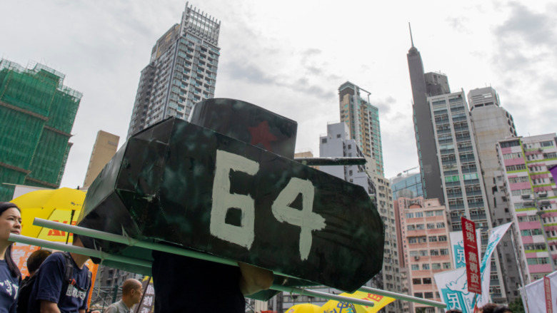 A protest sign shaped like a tank 