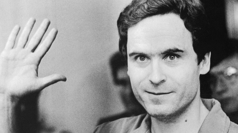 Ted Bundy smiles and waves to camera in court