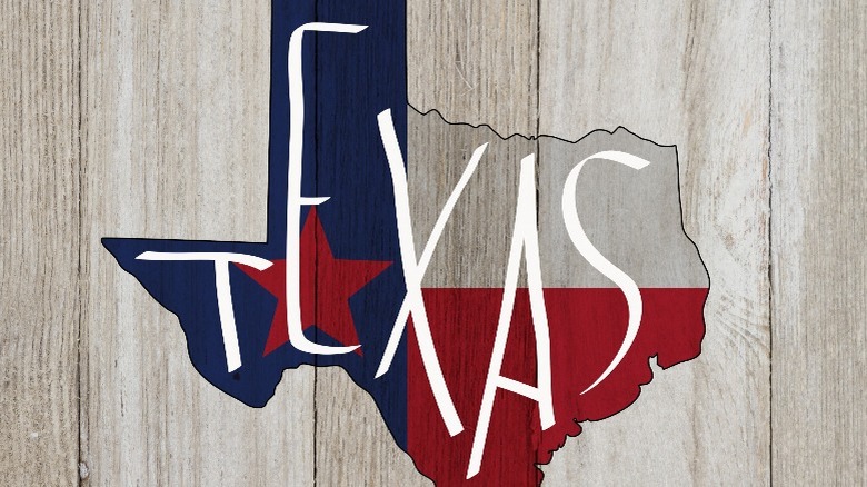 texas state flag over wood