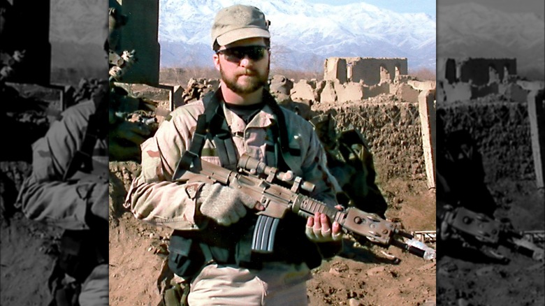 John Chapman holding rifle in uniform